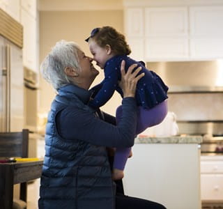 Een oudere vrouw speelt met haar kleindochter, die dankzij generation skipping kan profiteren van lagere successierechten.