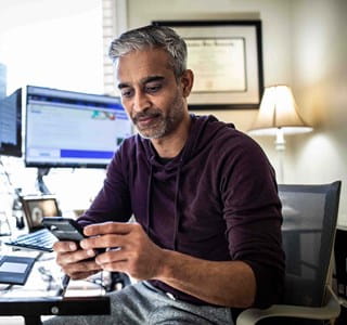 Homme qui utilise l’intelligence artificielle sur son ordinateur et téléphone
