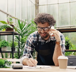 Freelancer vraagt telefonisch informatie op over mogelijke verzekeringen voor zijn professionele activiteiten.